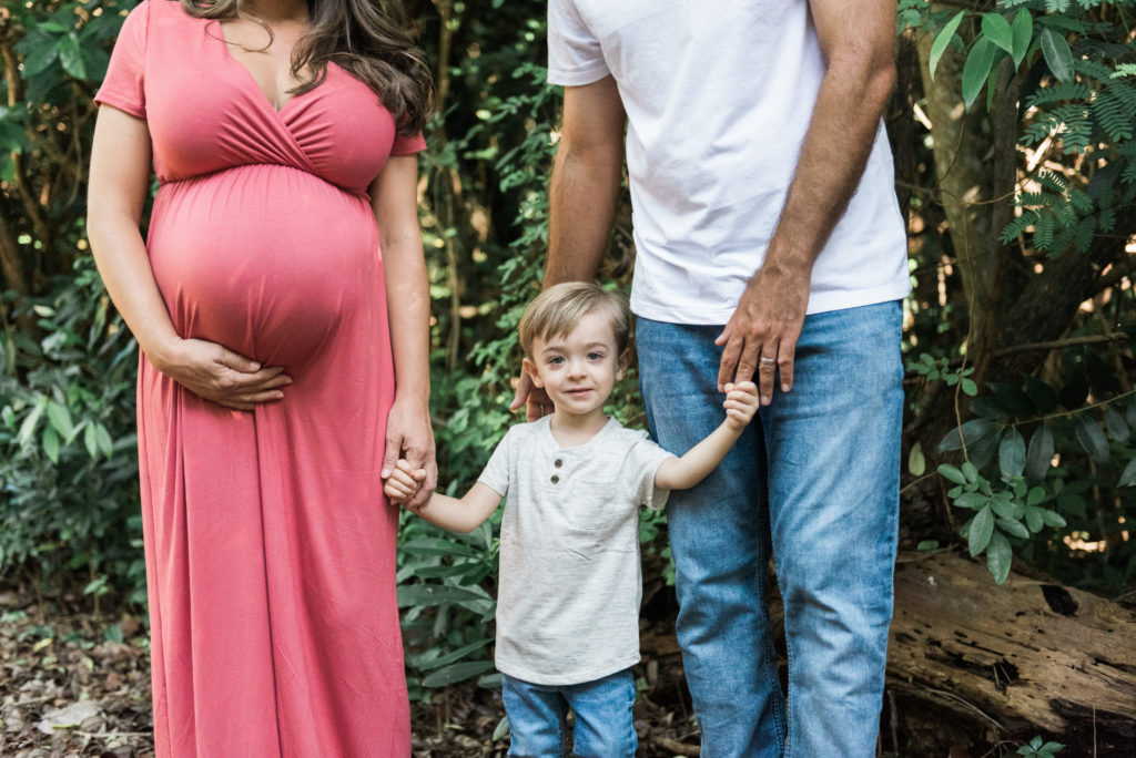 Little boy holding hands with mom and dad