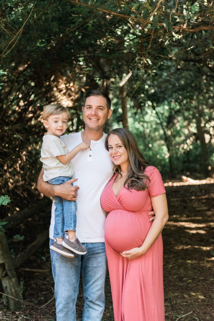 Dad holding son with arm around mom