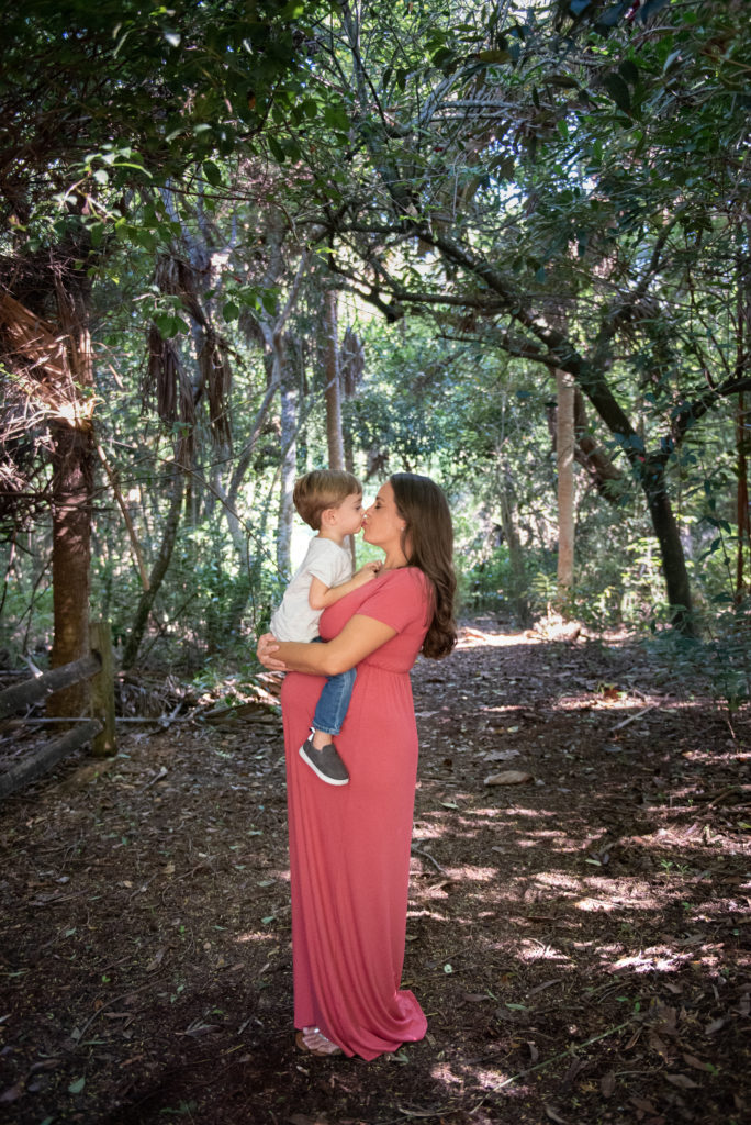 Mom holding son and kissing on the lips