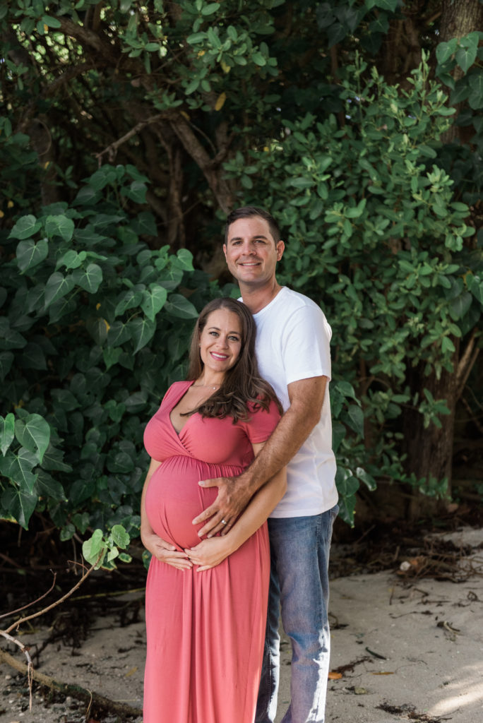 Mom leaning into dad holding belly