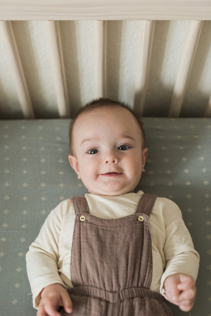 Baby in crib smiling