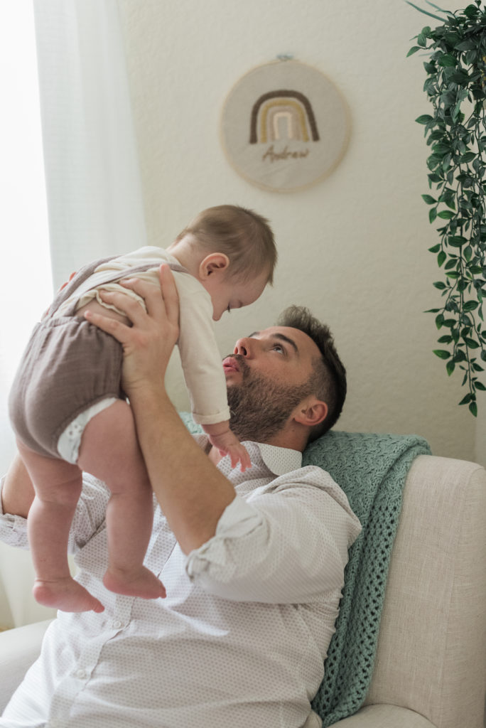 Dad lifting up baby boy