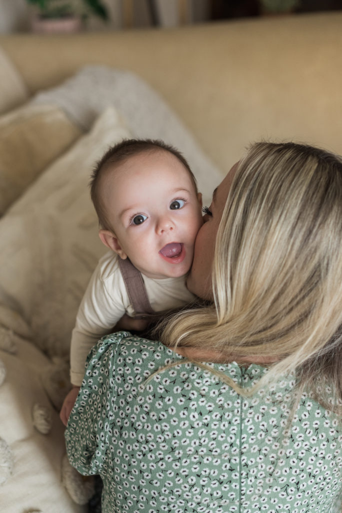 Mom kissing baby