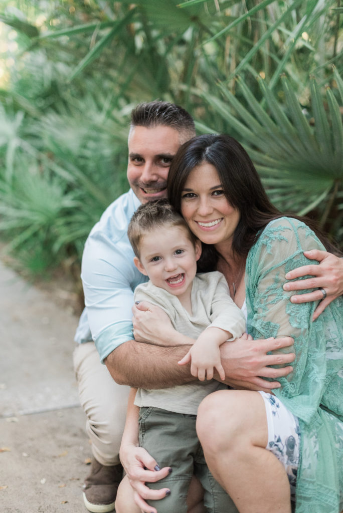 Mom, dad and son giving big hugs