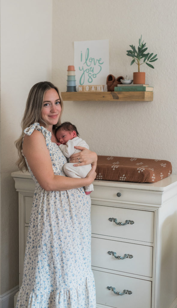 Mom holding baby looking at camera