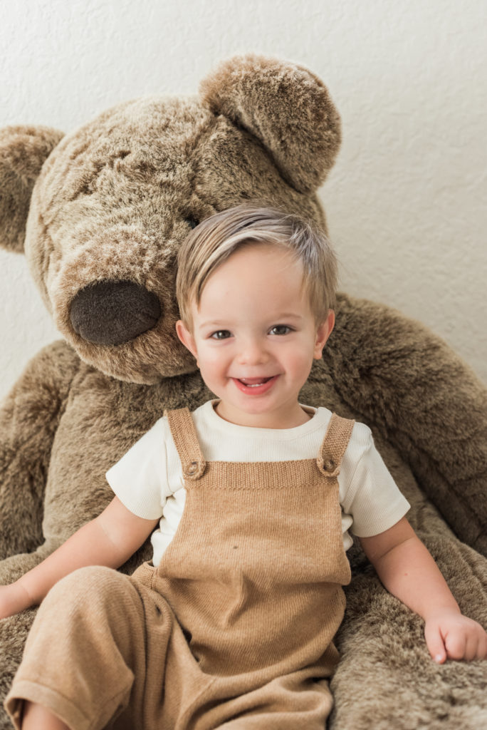 Big brother sitting with a bear