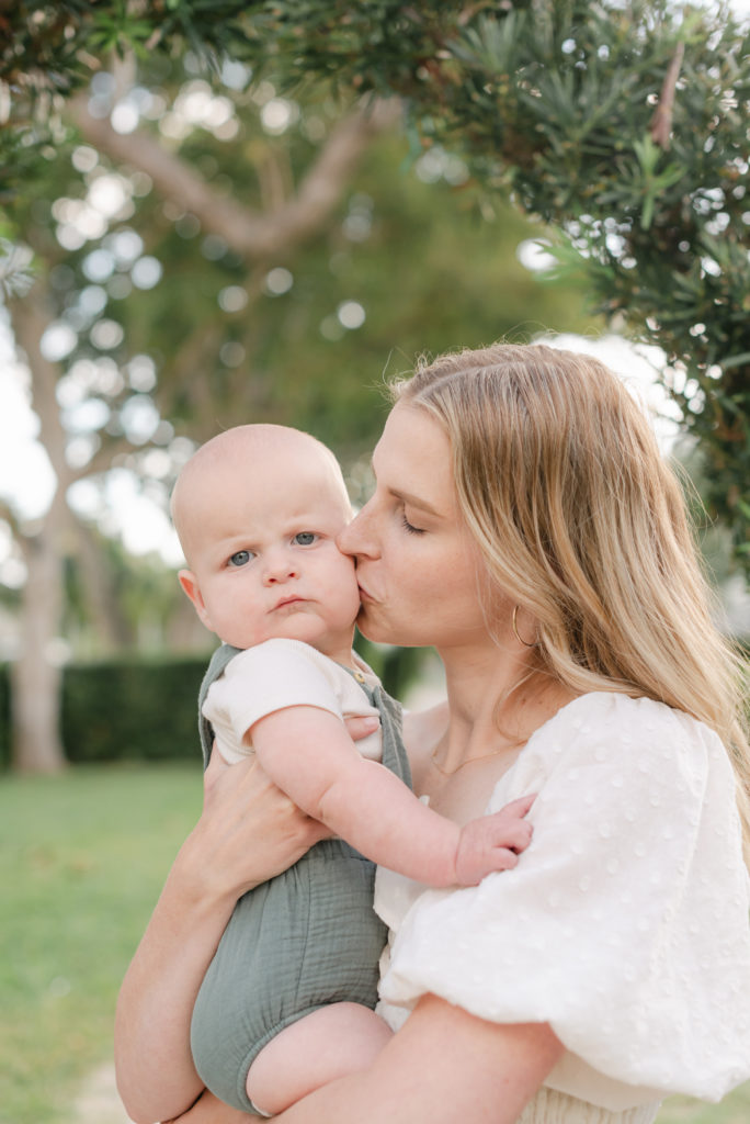 Mom kissing son's cheek up close