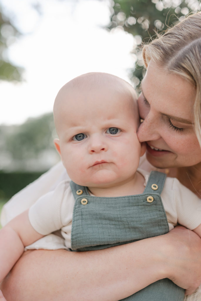 Mom's nost to baby's cheek