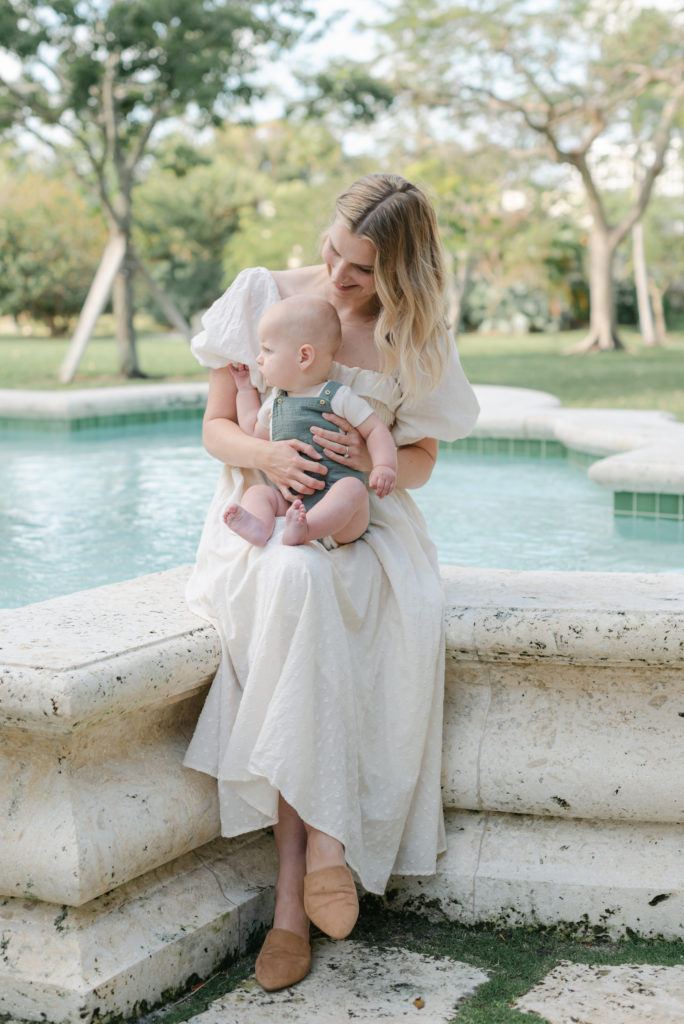 Mom and son sitting by fountain