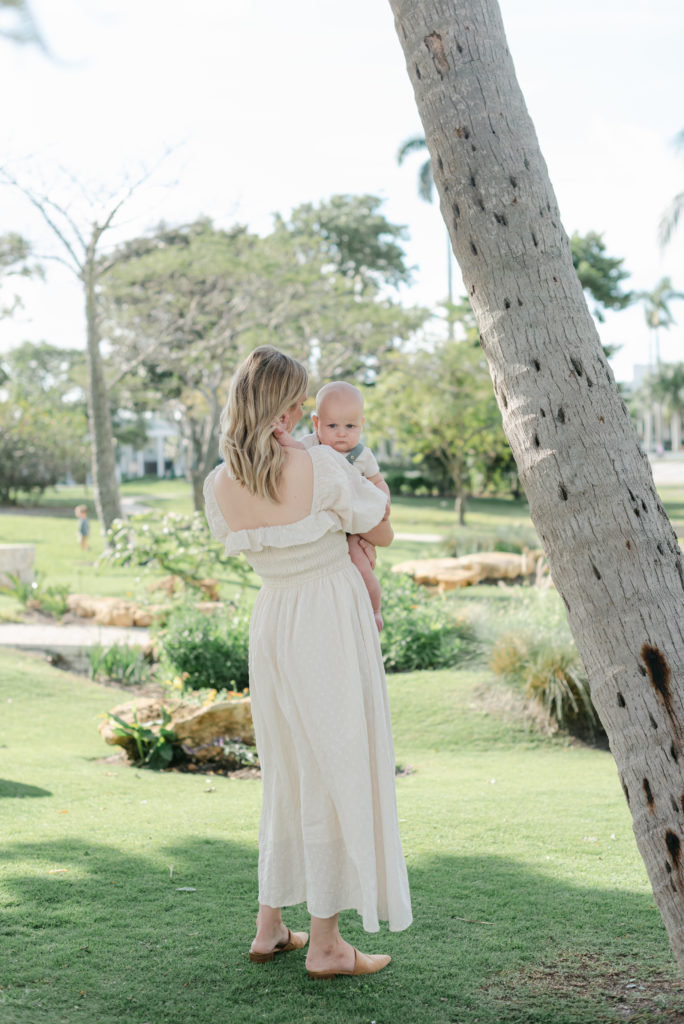 Mom holding baby with her back to the camera