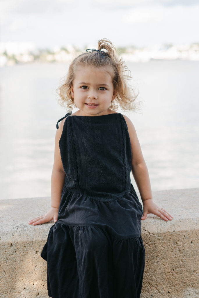 Girl sitting on ledge, smiling