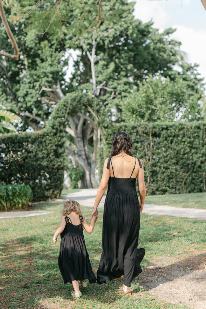 Mom and daughter holding hands walking away