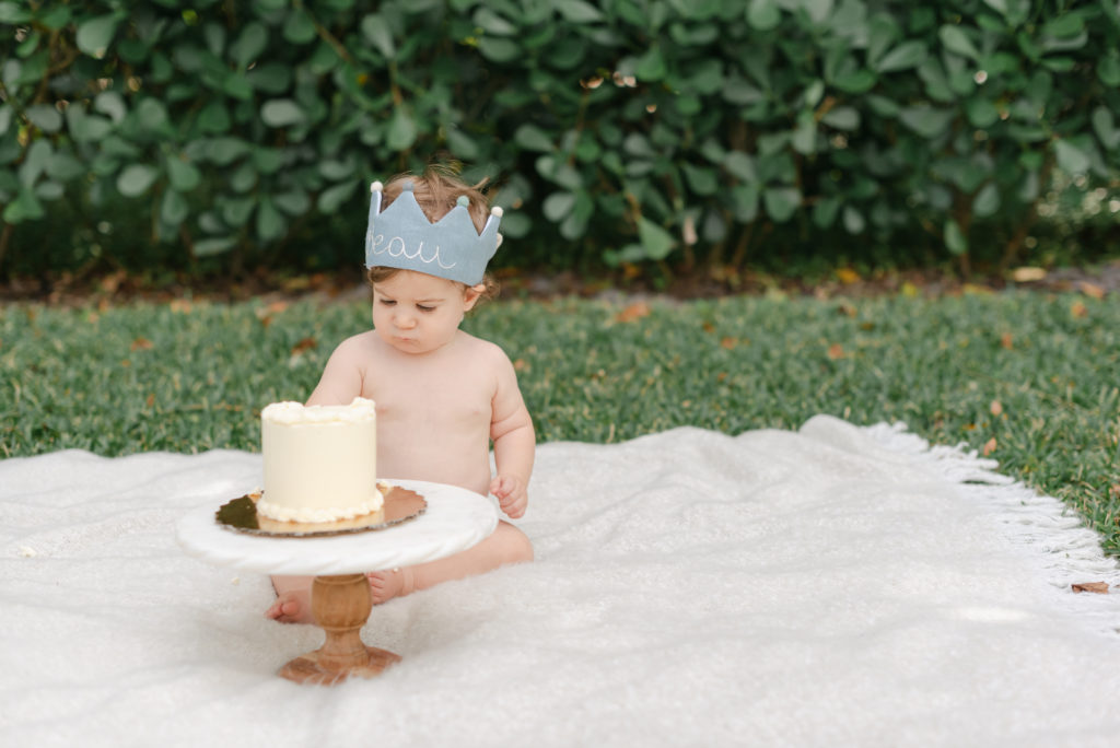 Boy wearing crown with cake