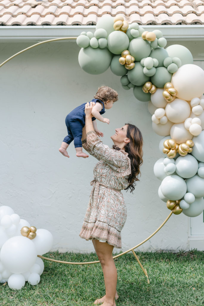 Mom holding up baby