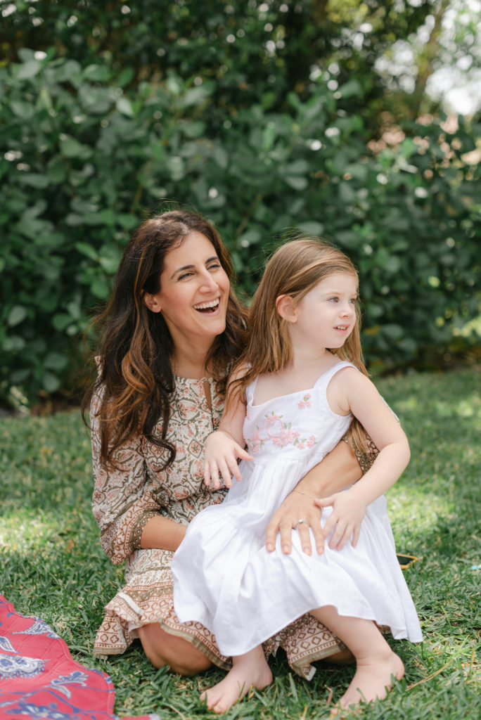 Mom and daughter looking away smiling