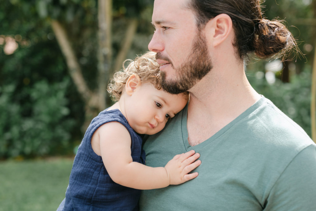 Boy laying on dad's chest