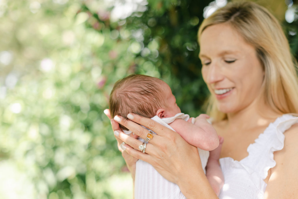 Baby in focus while mom is holding her