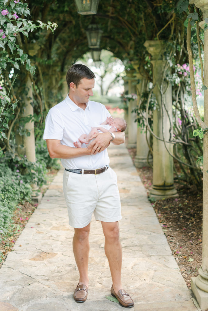 Dad holding baby looking down