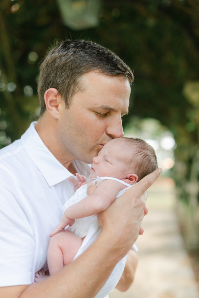 Dad kissing baby girl