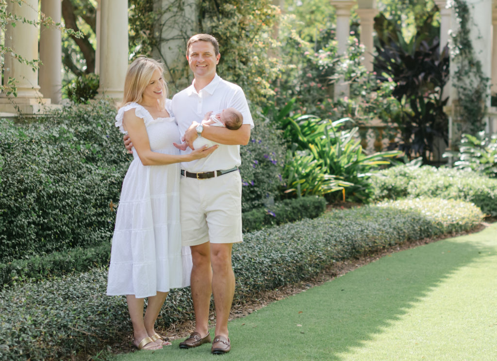 Mom looking at baby, dad looking at camera both smiling