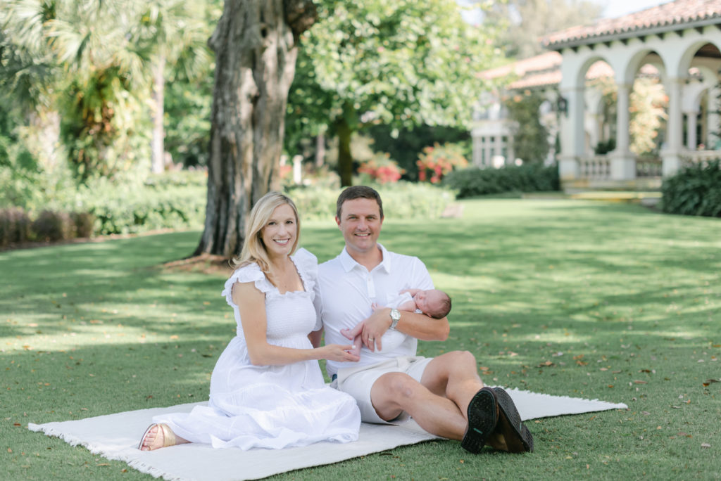 Mom and dad sitting down, holding baby