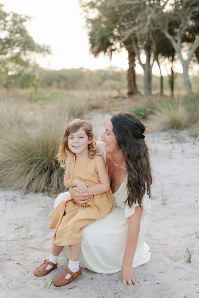 Mom crouching down smiling at daughter