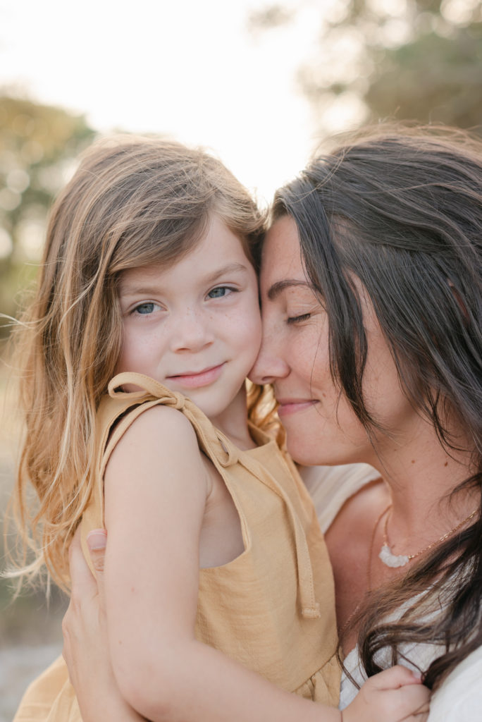 Close up of mom snuggled up to daughter