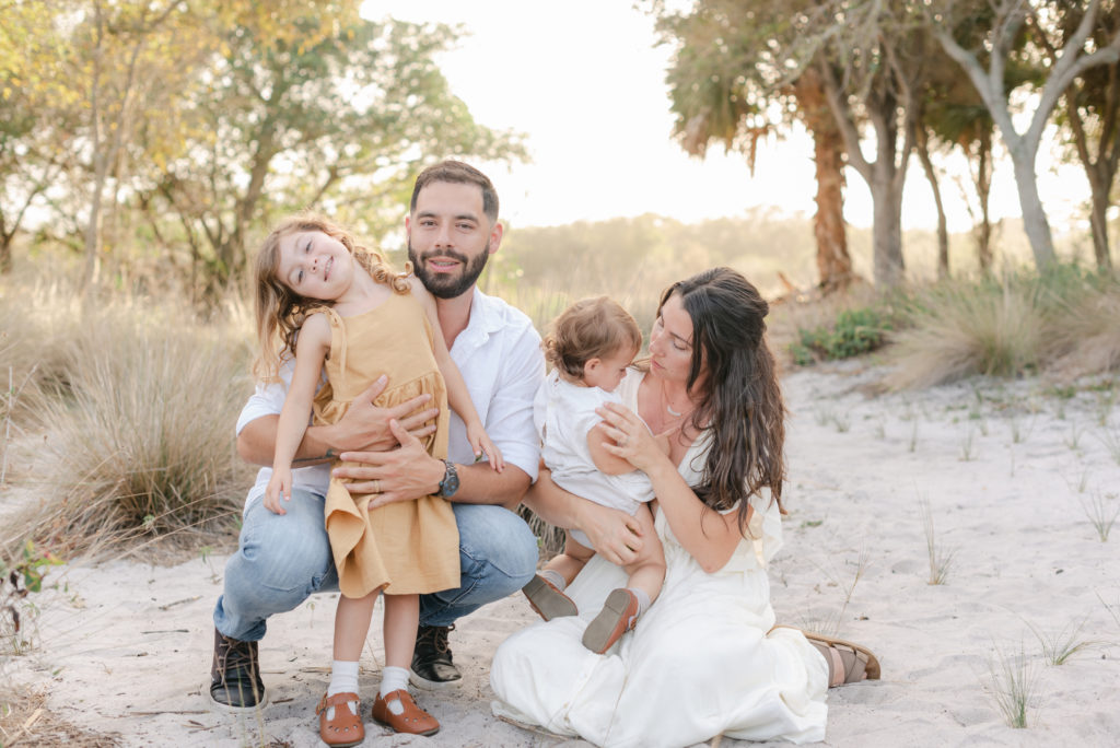 Family of four photo.  Parents sitting down