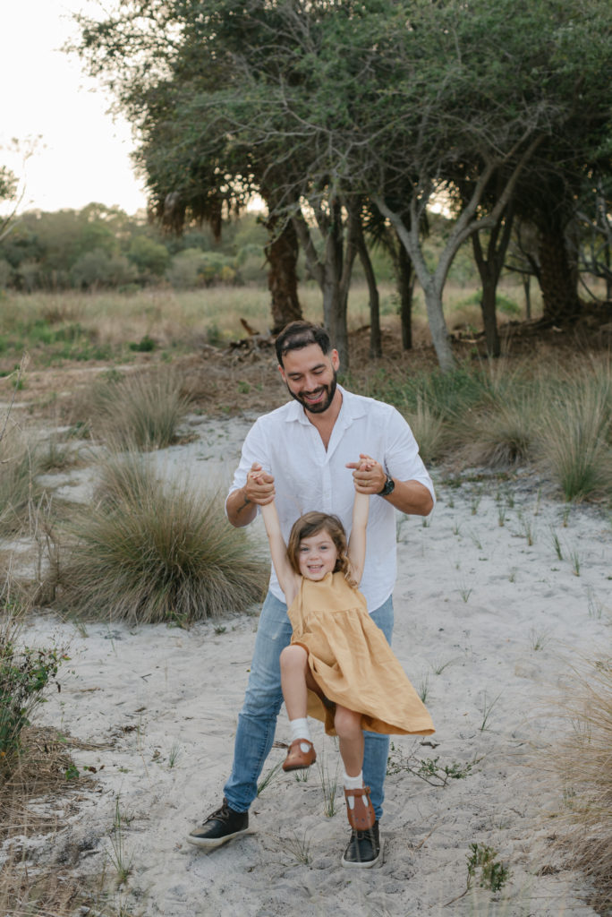 Dad swinging daughter