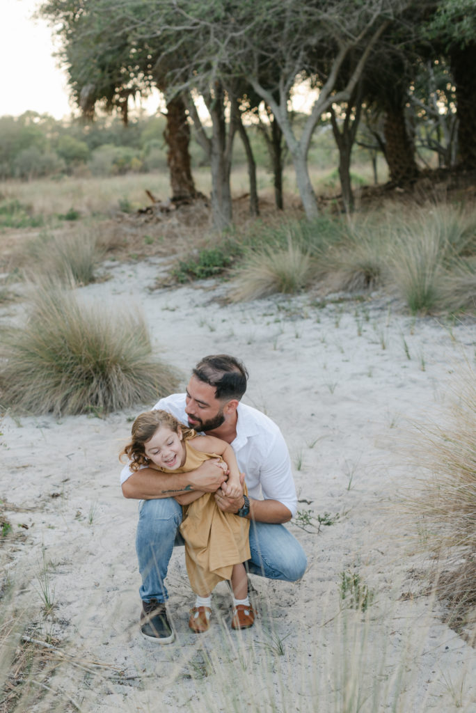 Dad snuggling daughter