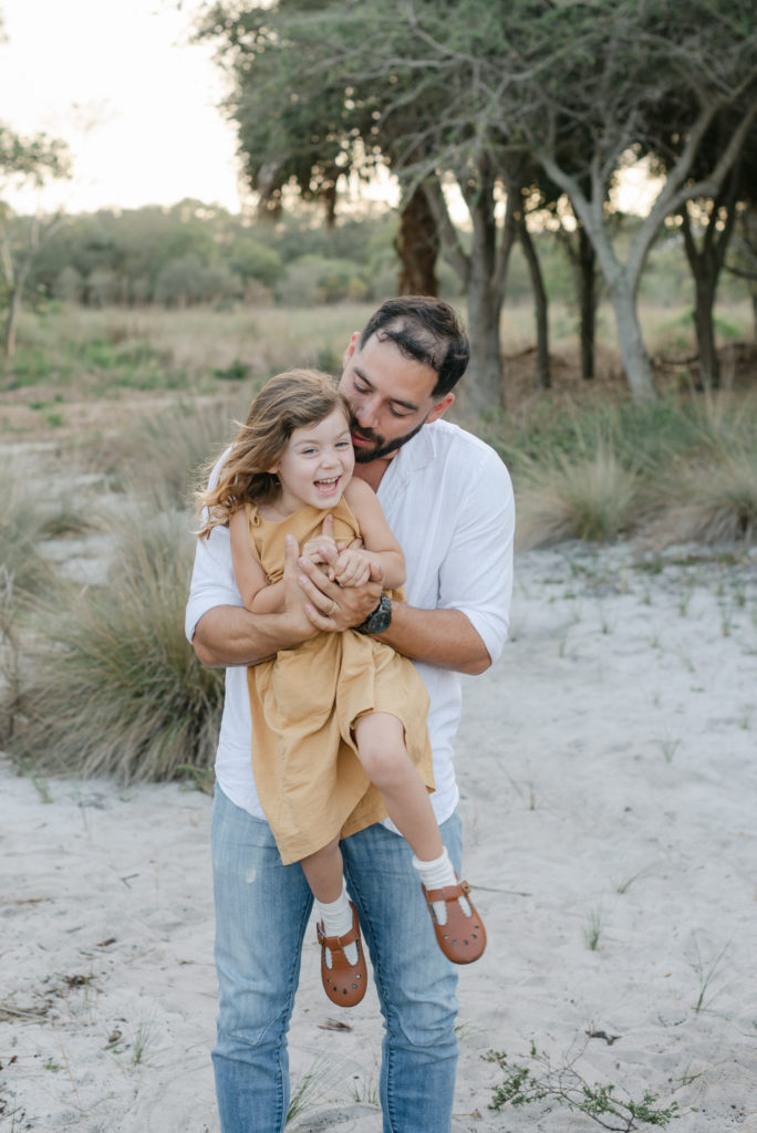 Dad lifting up hugging daughter