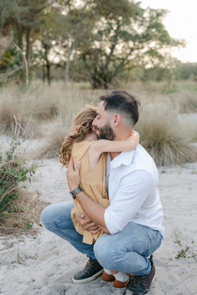 Side view of dad and daughter hugging