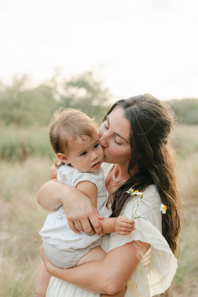 Mom kissing baby's cheek