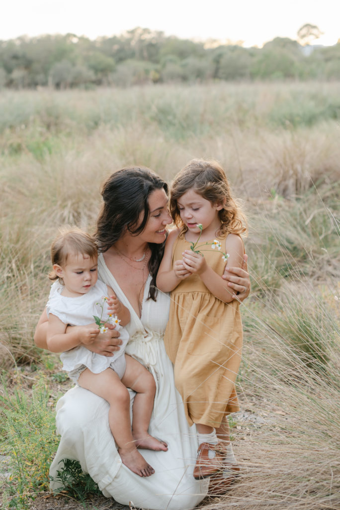 Mom crouched down with girls