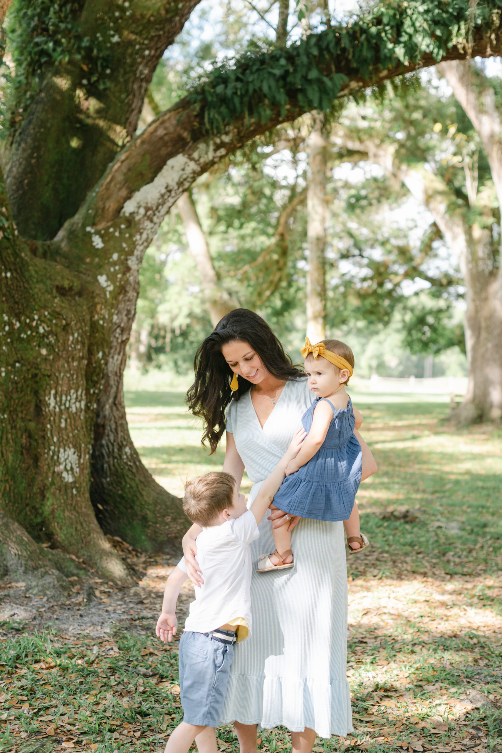 Mom looking down at son, holding daughter