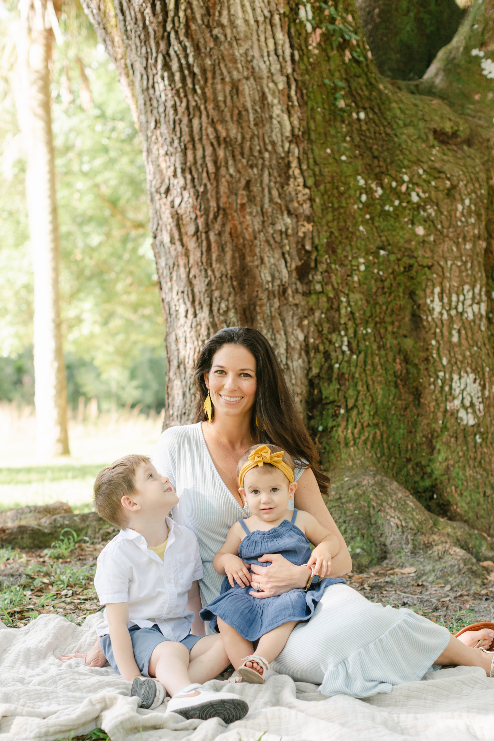 Mom and daughter smiling, son looking at mom