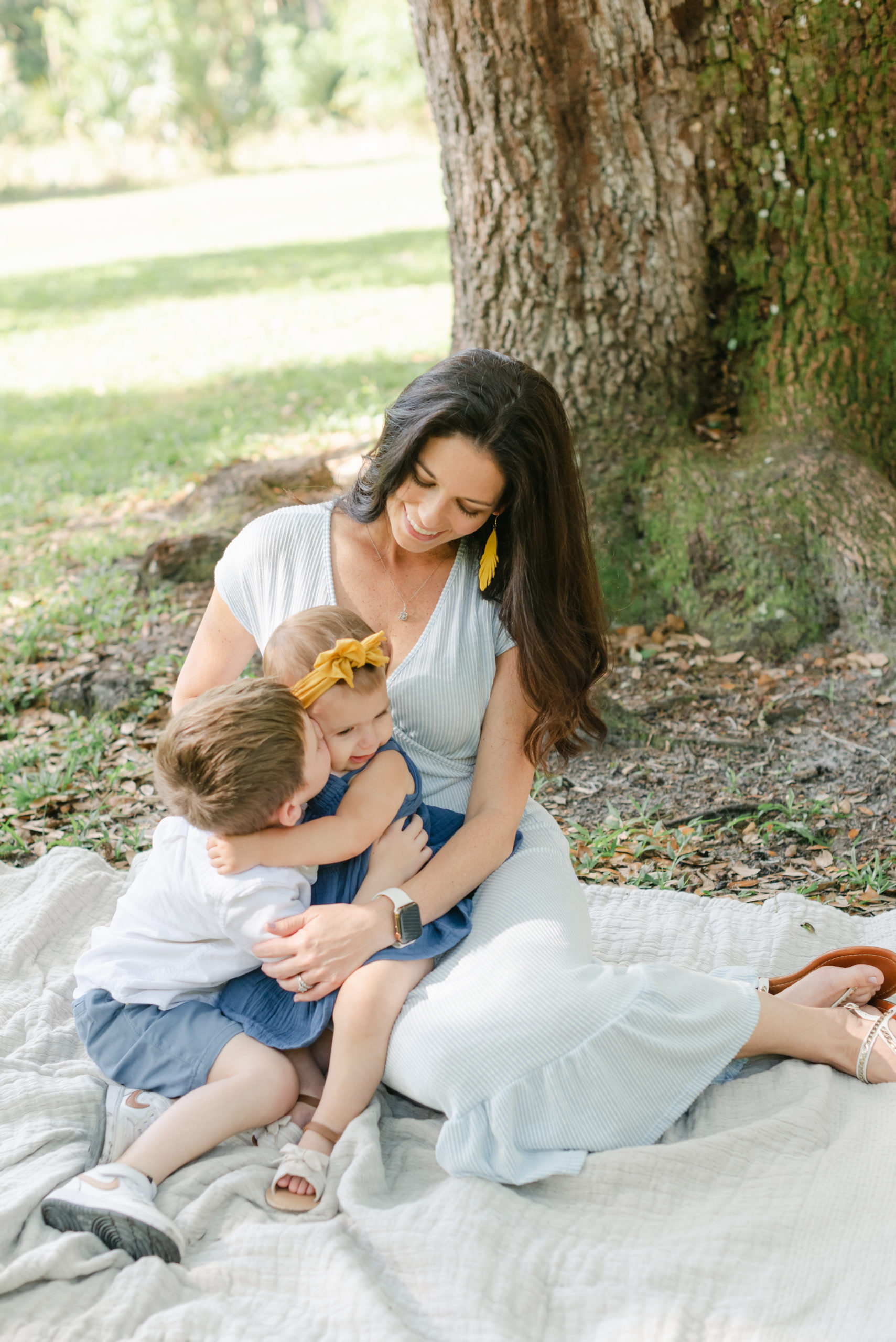 Kids hugging in mom's lap