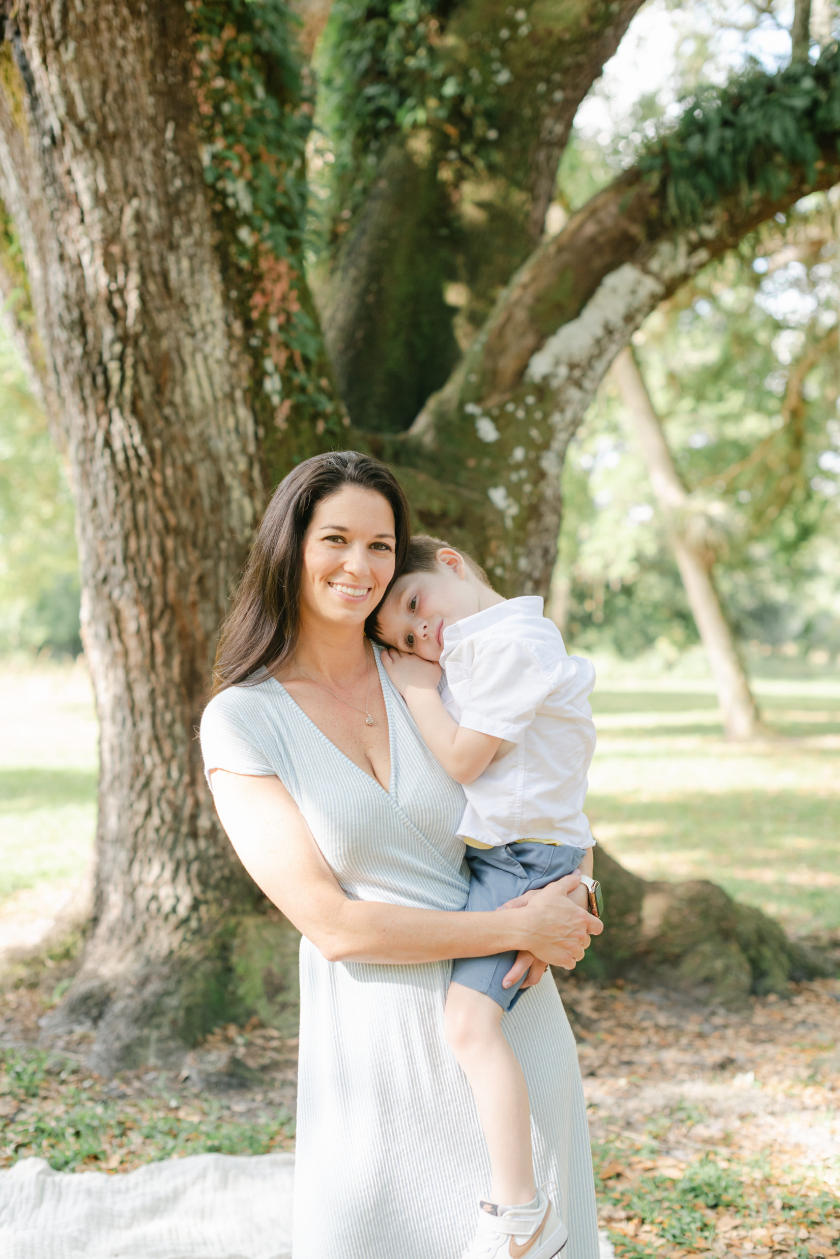 Mom holding son, resting head on mom's shoulder