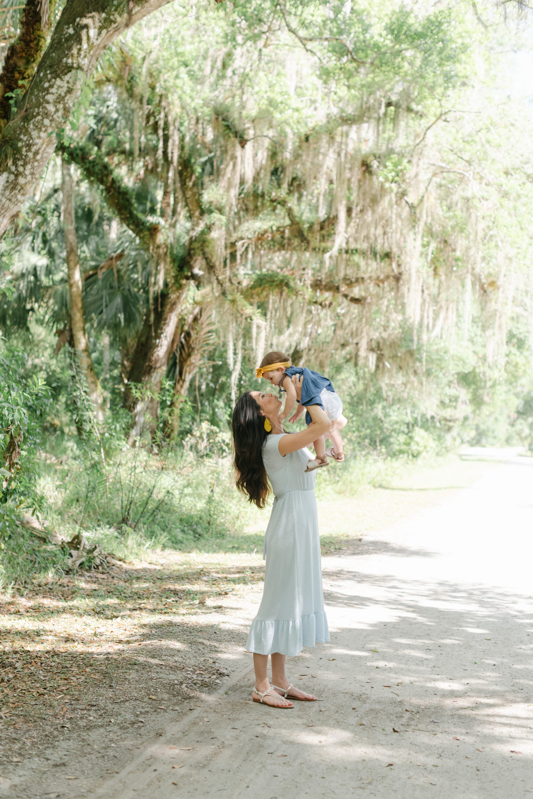 Mom holding up daughter