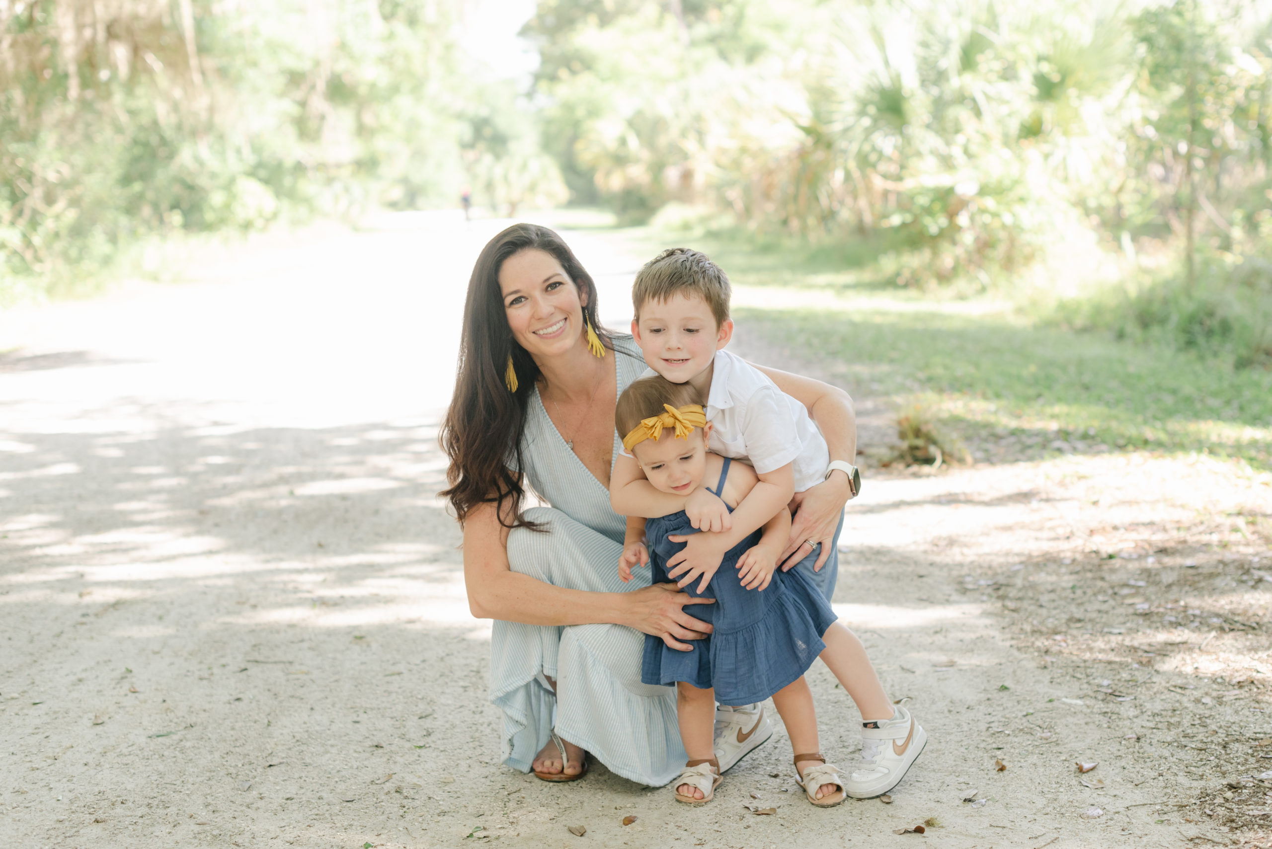 Mom crouched down with kids near her