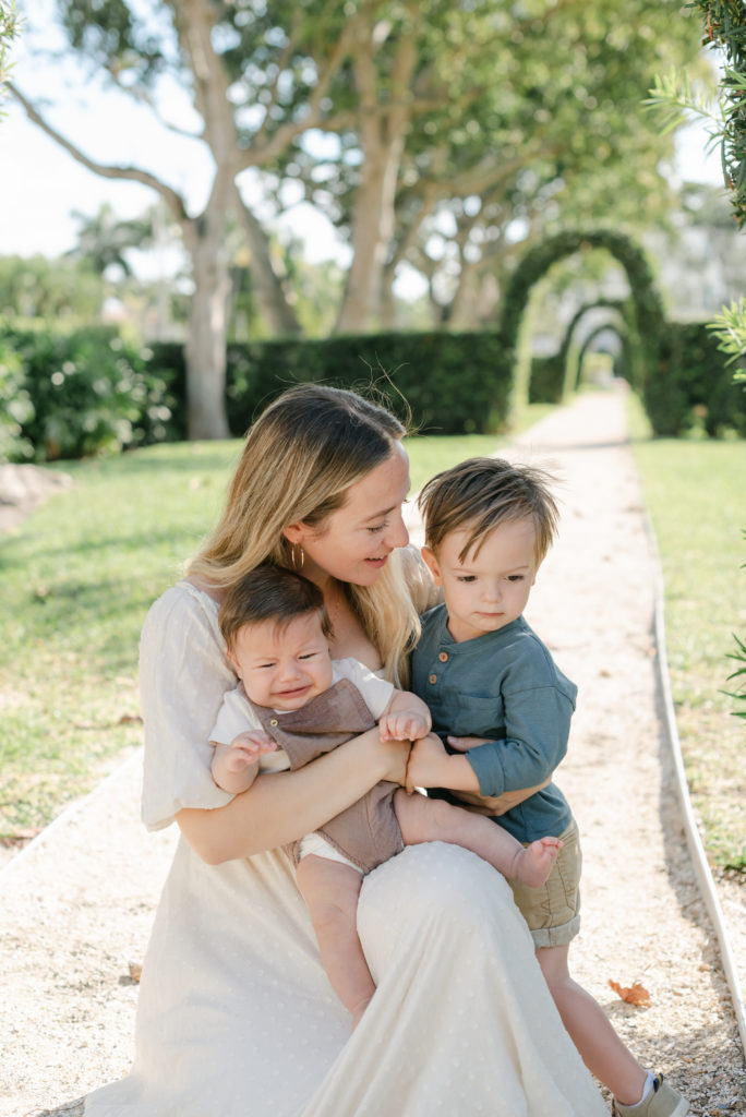 Mom crouching down looking at son