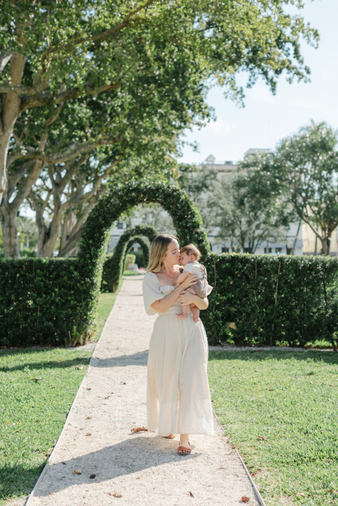 Mom walking kissing baby