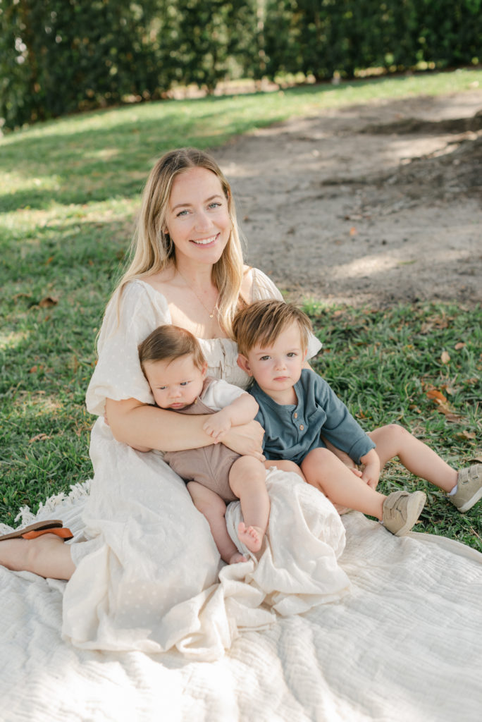 Mom sitting with both sons on her lap