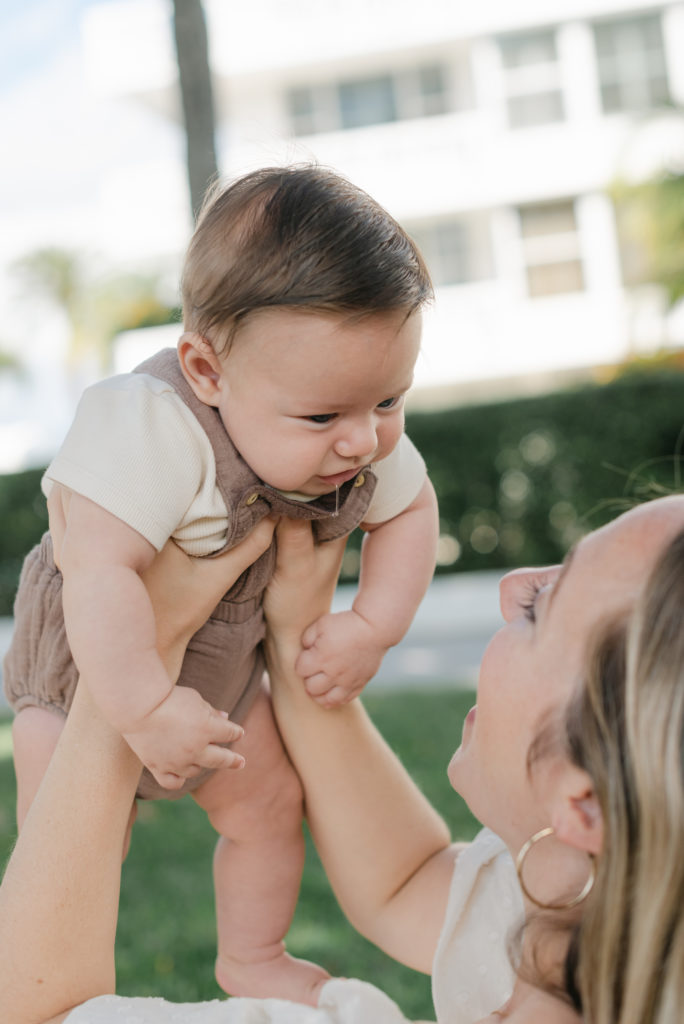 Baby boy being held up, drool coming out of his mouth!