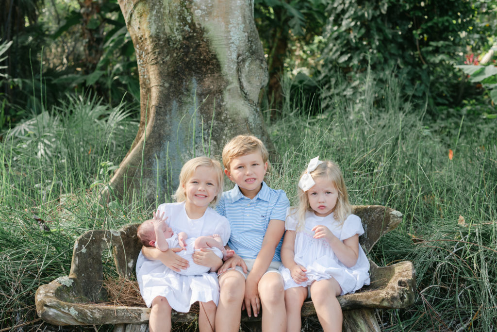 All siblings, holding baby