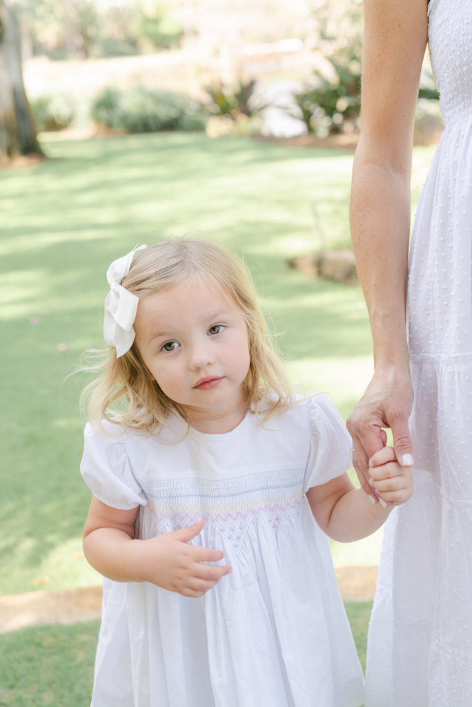 Mom holding daughter's hand