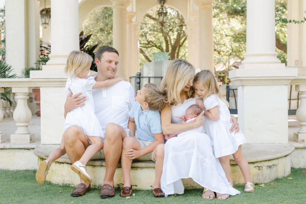 Family sitting on step snuggling up with each other