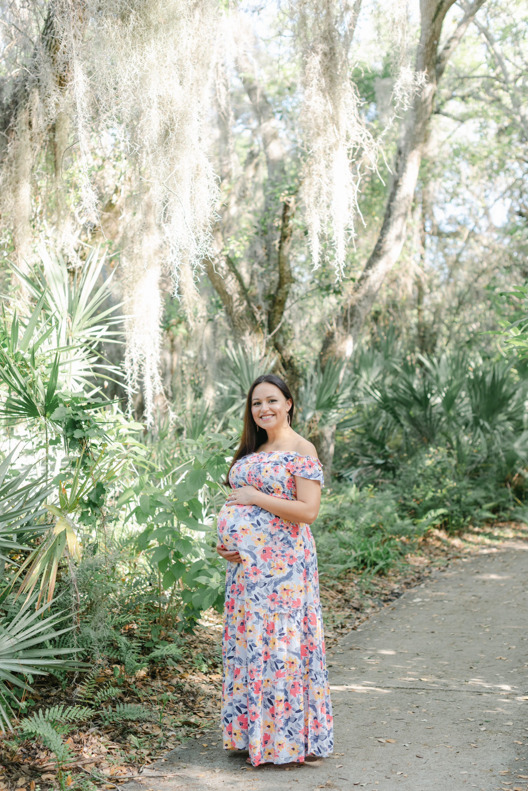 Mom holding belly, smiling