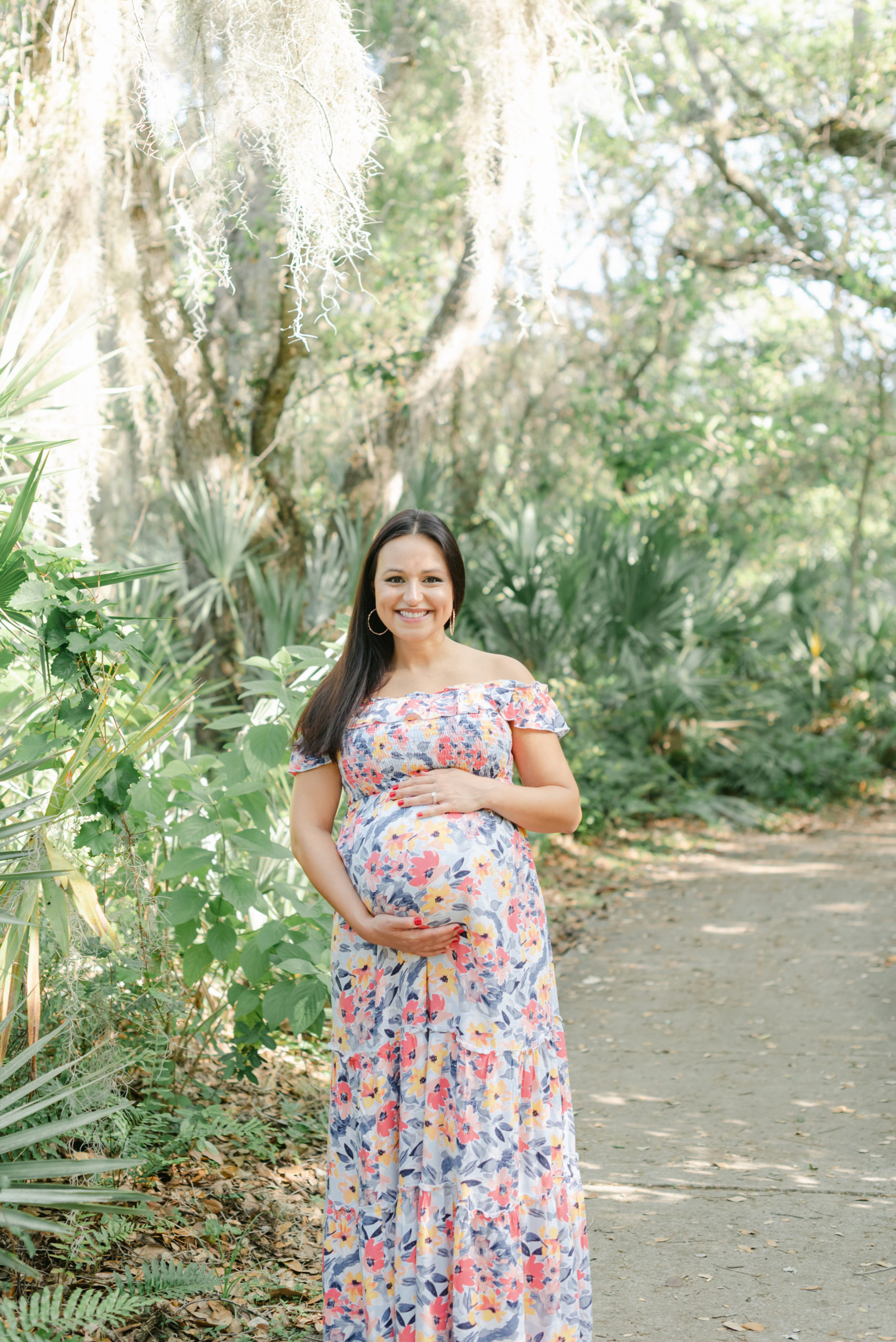 Mom looking straight on at camera, holding belly