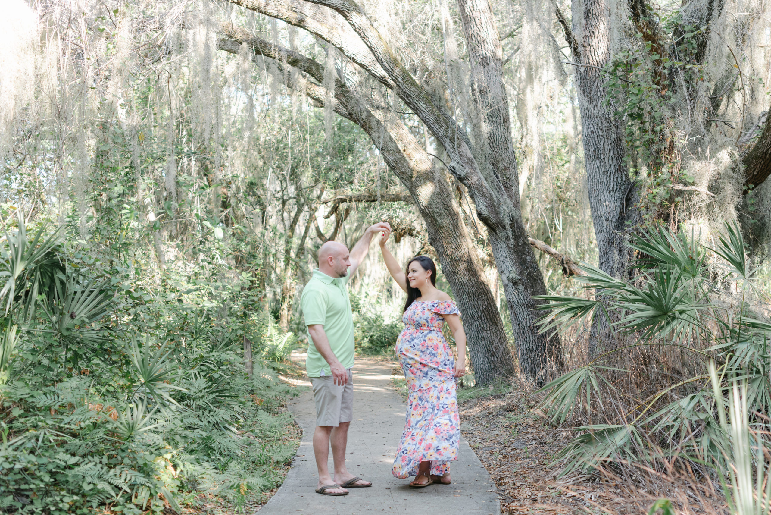 Mom and dad dancing under the trees